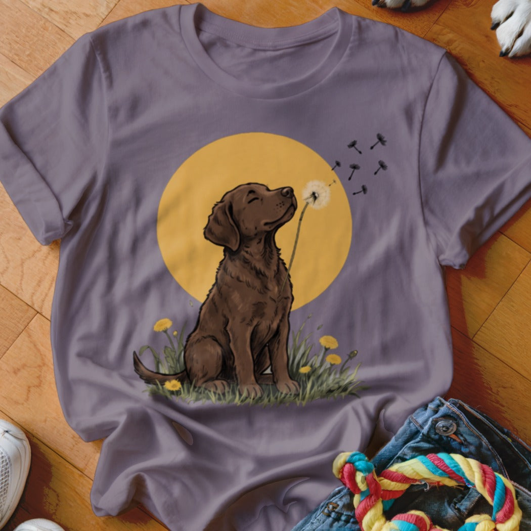 Gray crewneck t-shirt featuring a graphic of a brown dog blowing dandelion seeds against a yellow circle background.