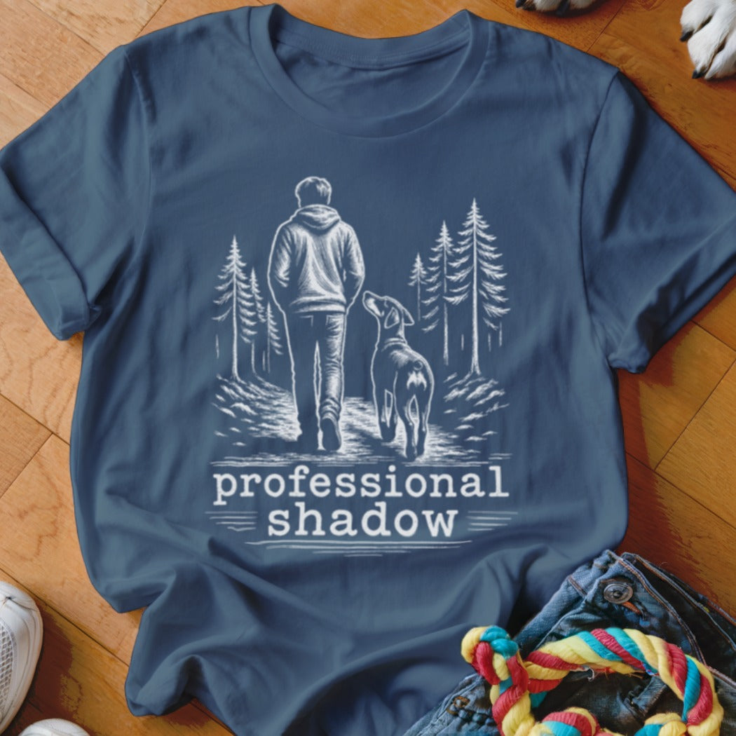 T-shirt with "professional shadow" text and graphic of person and dog walking in trees.