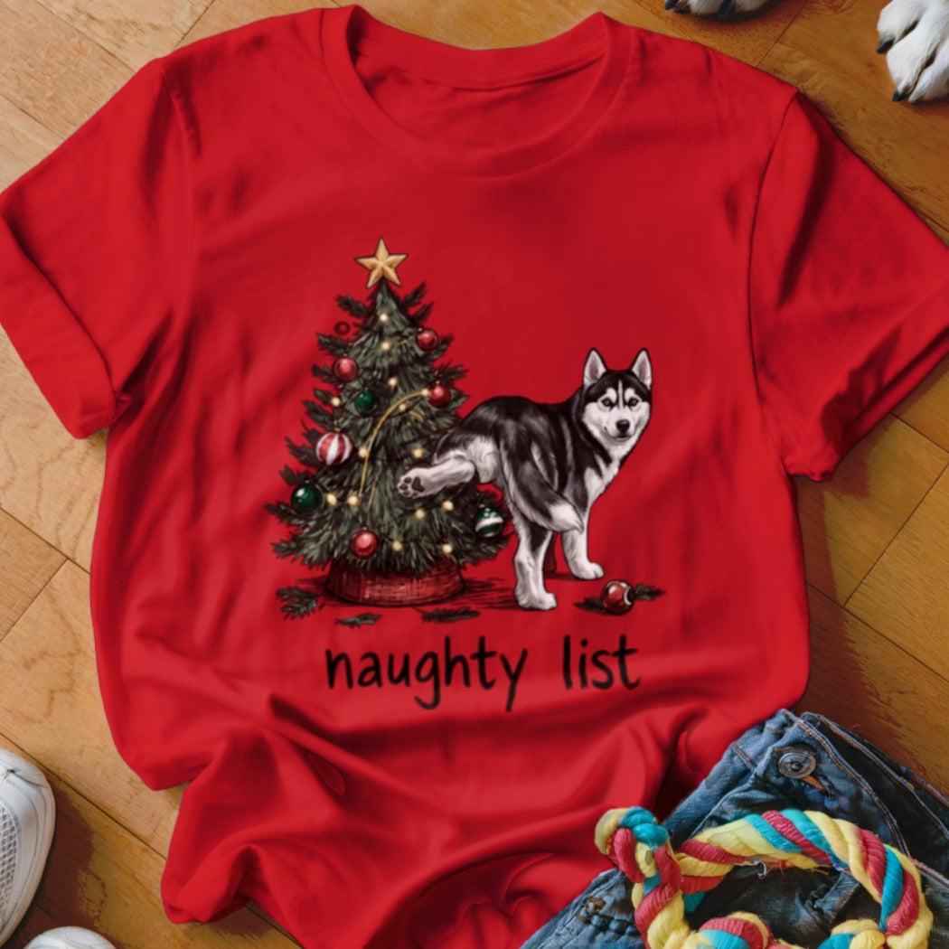 Red t-shirt featuring a husky urinating on a Christmas tree with the text naughty list.