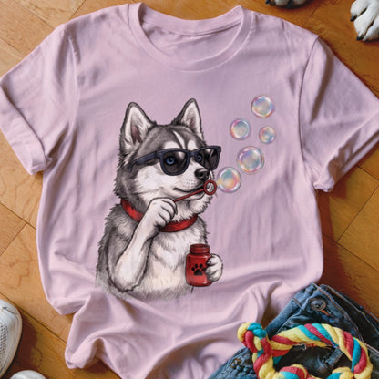 A light pink crewneck t-shirt featuring a graphic of a husky wearing sunglasses and blowing bubbles.