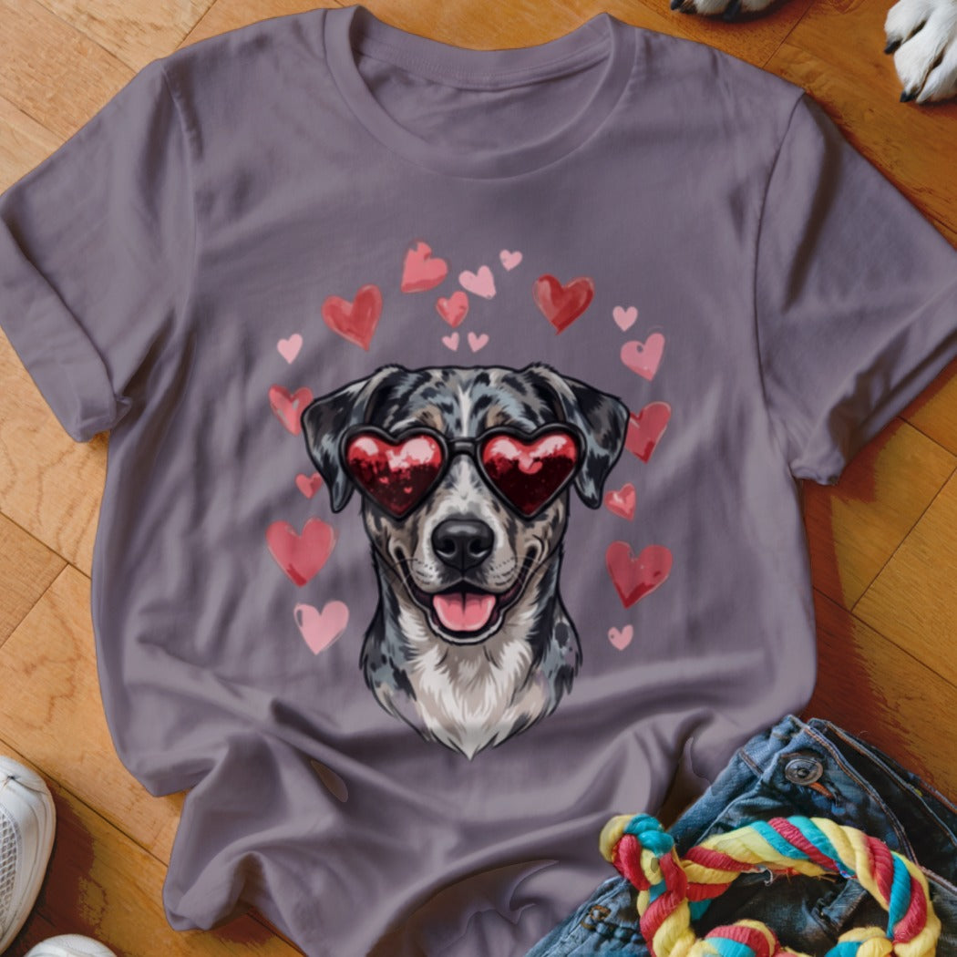 A purple t-shirt featuring a graphic of a dog wearing heart-shaped sunglasses surrounded by floating pink hearts.