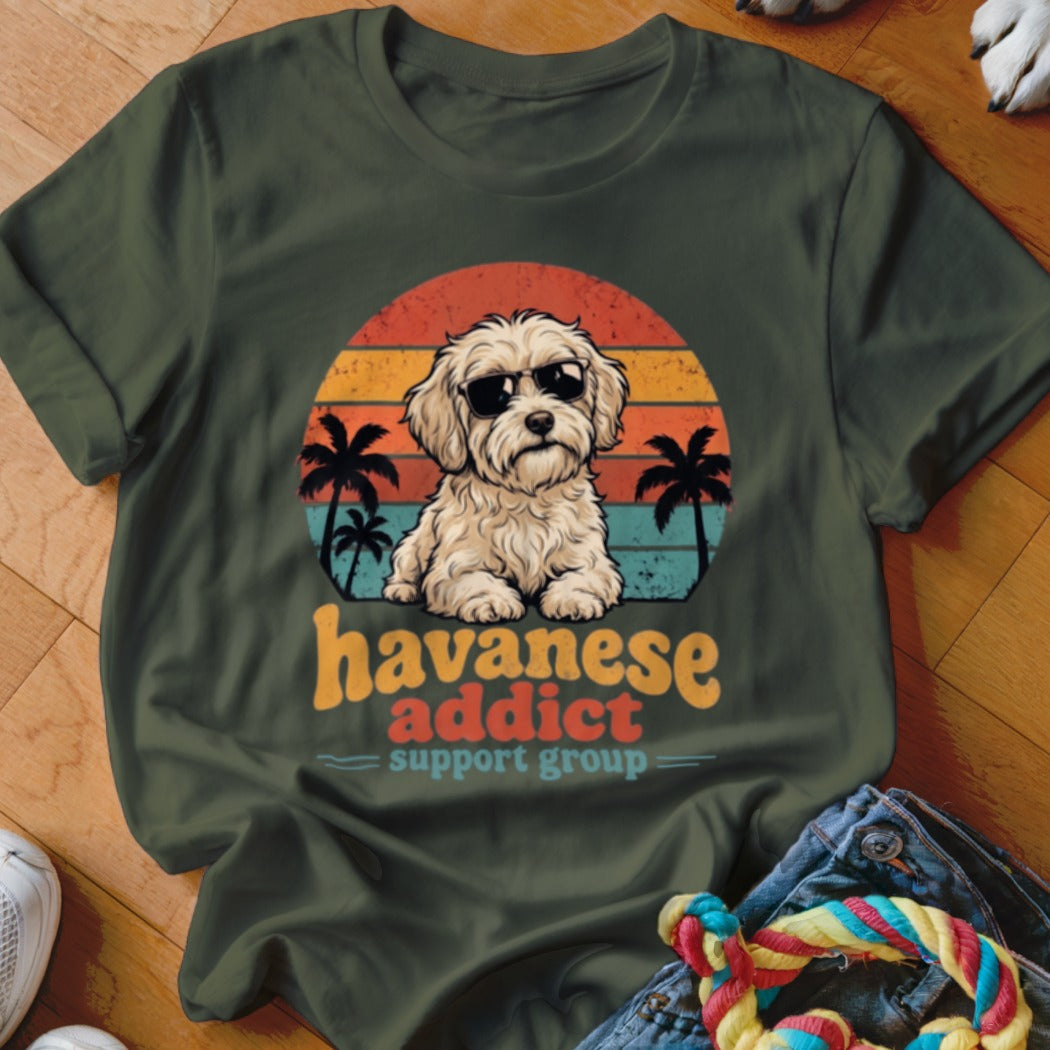 An olive green t-shirt with a retro Havanese dog graphic and text reading havanese addict support group.