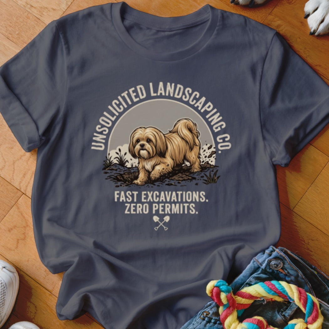 Dark t-shirt with graphic of dog and text "UNSOLICITED LANDSCAPING CO. FAST EXCAVATIONS. ZERO PERMITS."