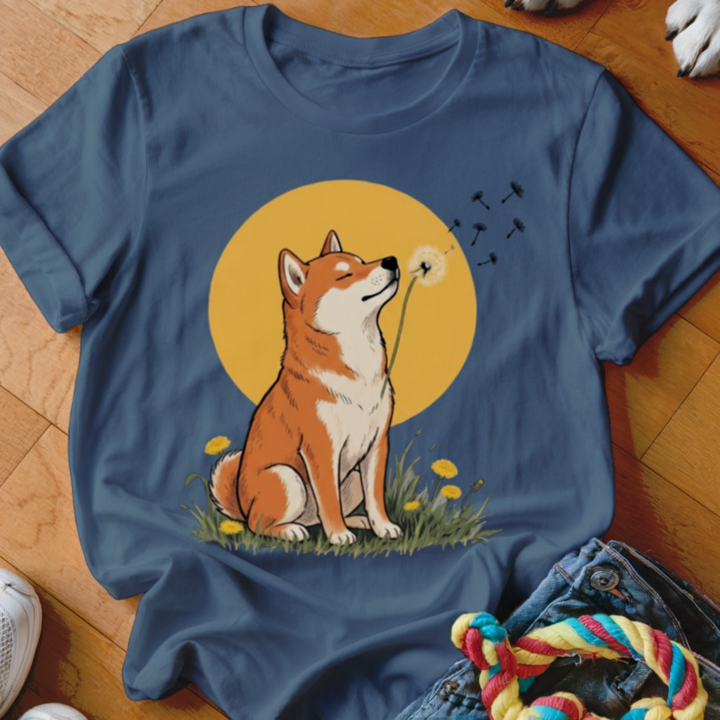 Blue crewneck t-shirt featuring a graphic of a Shiba Inu sniffing a dandelion against a yellow circle.