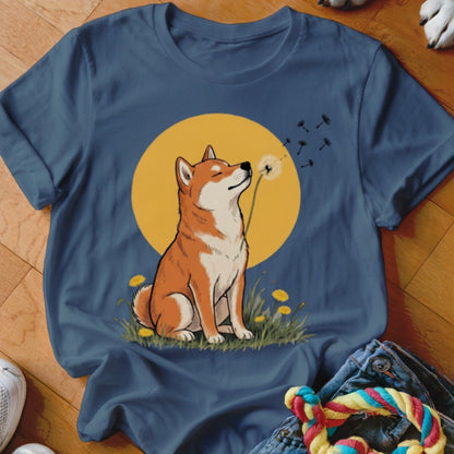 Blue crewneck t-shirt featuring a graphic of a Shiba Inu sniffing a dandelion against a yellow circle.