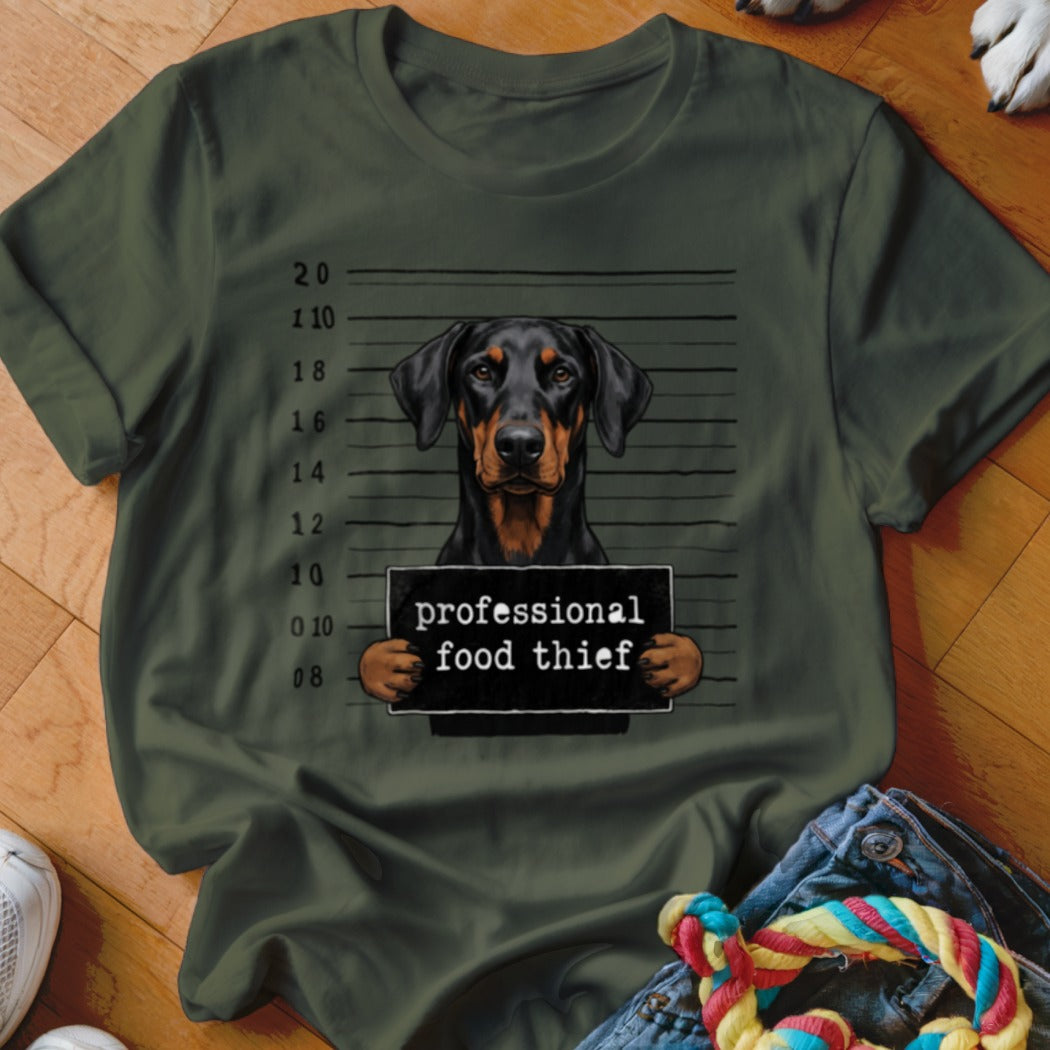 Doberman mugshot on a green t-shirt with the text "professional food thief".