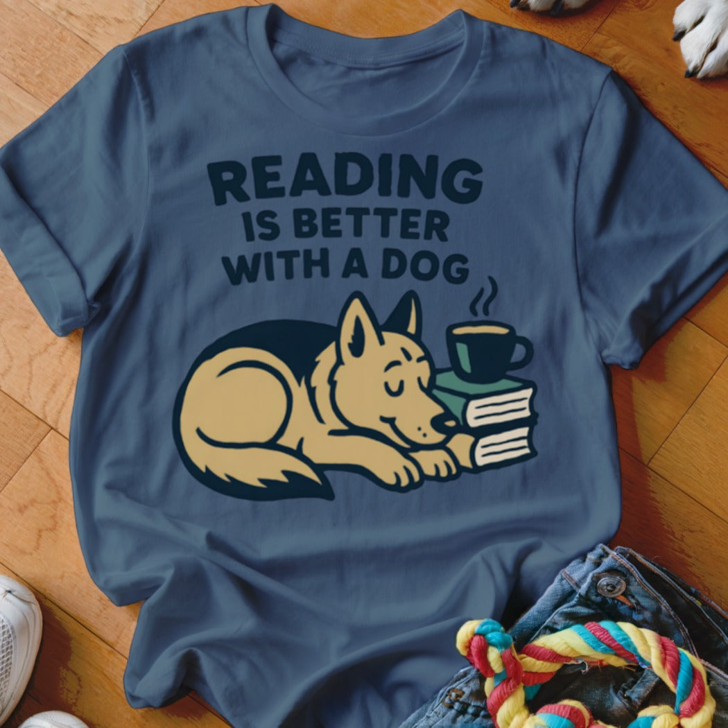 T-shirt with "Reading is better with a dog" text and a sleeping dog by books.