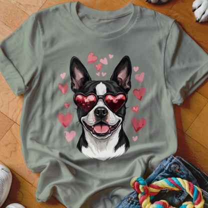 Sage green t-shirt featuring a graphic of a Boston Terrier wearing heart-shaped sunglasses surrounded by pink hearts.
