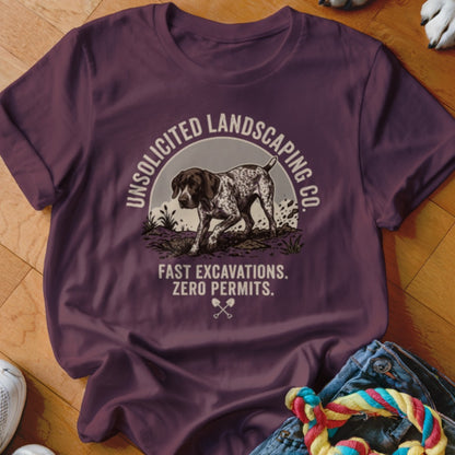 Plum t-shirt with dog graphic and text: Unsolicited Landscaping Co. Fast Excavations. Zero Permits.