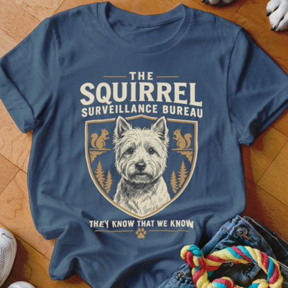 Blue t-shirt featuring a West Highland White Terrier graphic and text reading The Squirrel Surveillance Bureau.