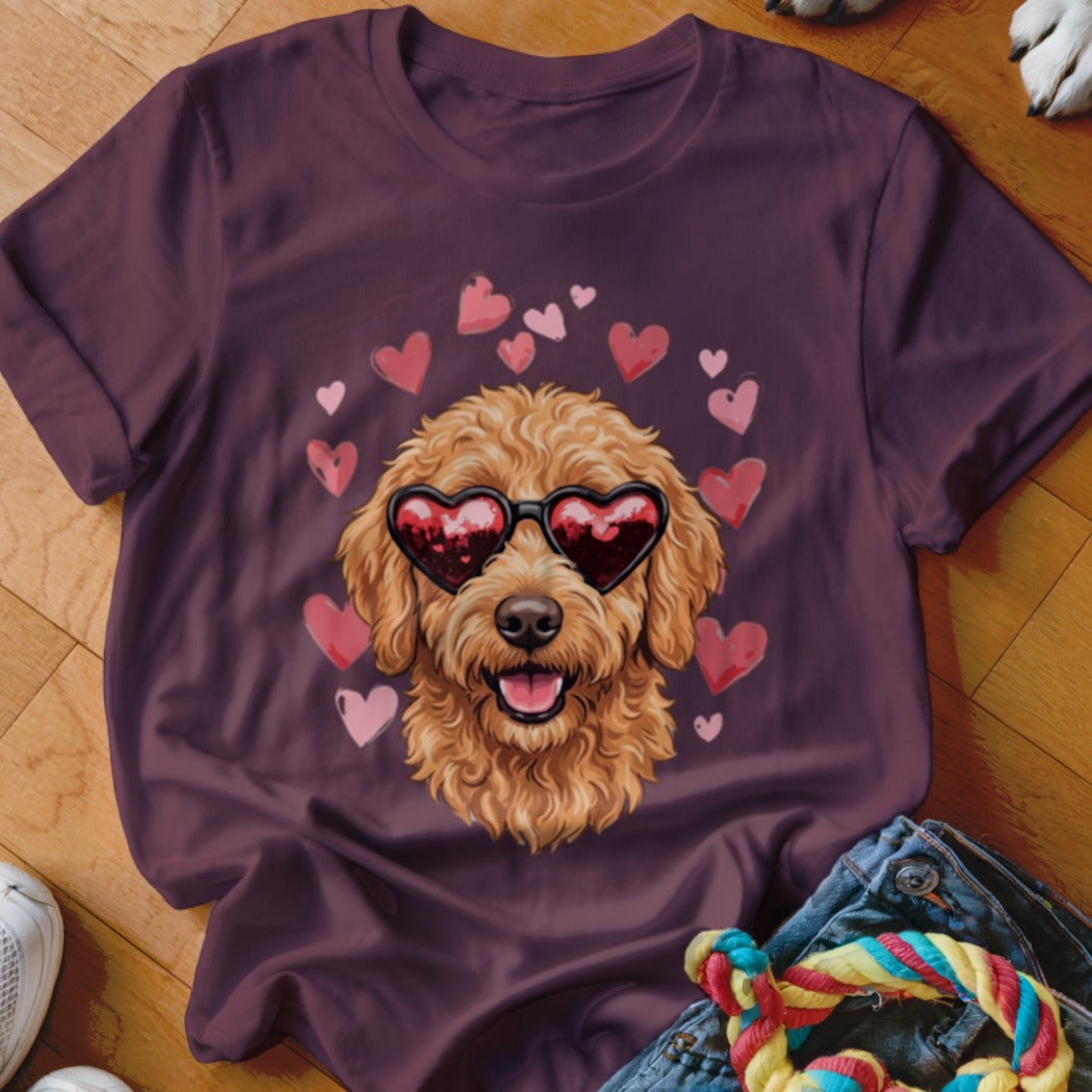 Maroon crewneck t-shirt featuring a graphic of a fluffy golden dog wearing heart-shaped sunglasses, surrounded by pink hearts.