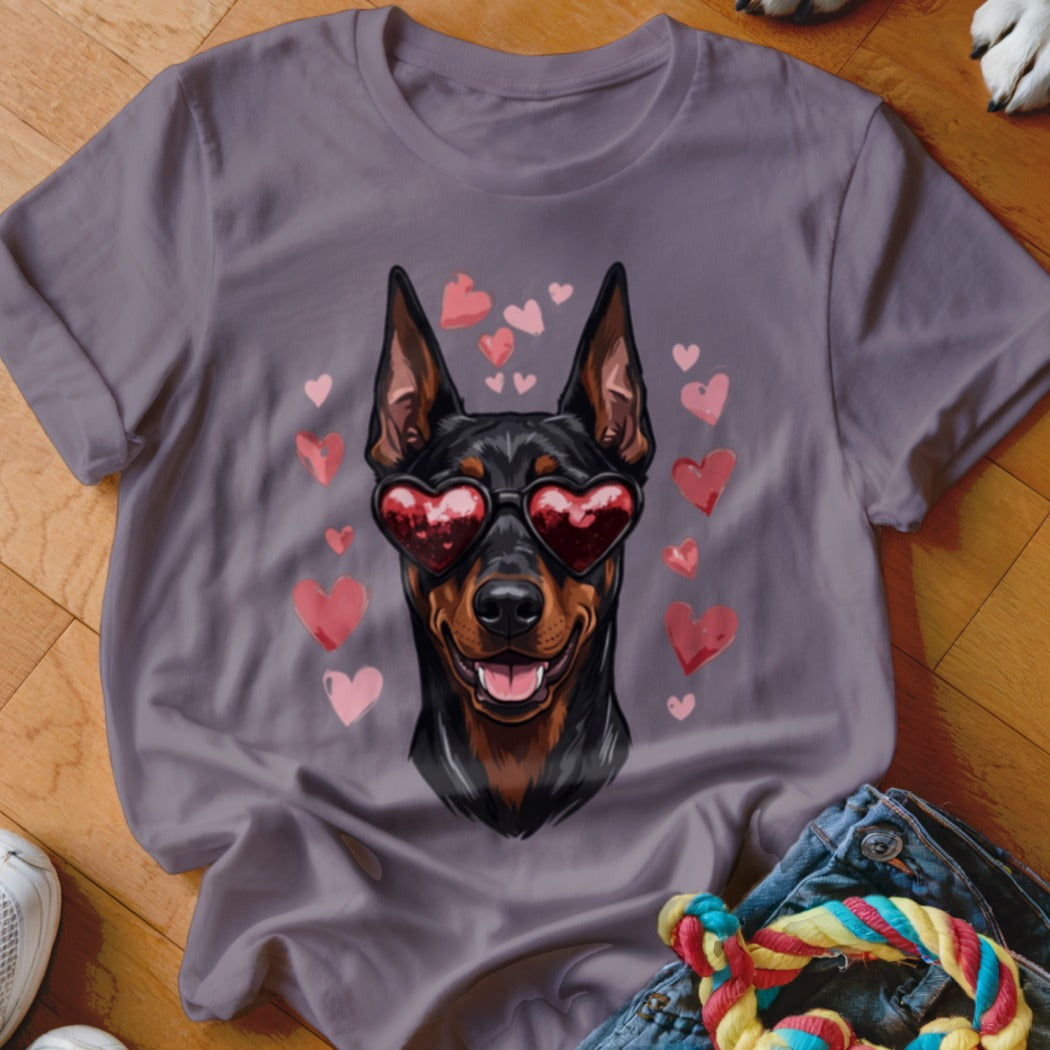 Mauve short-sleeve t-shirt featuring a graphic of a Doberman wearing heart-shaped sunglasses surrounded by pink hearts.