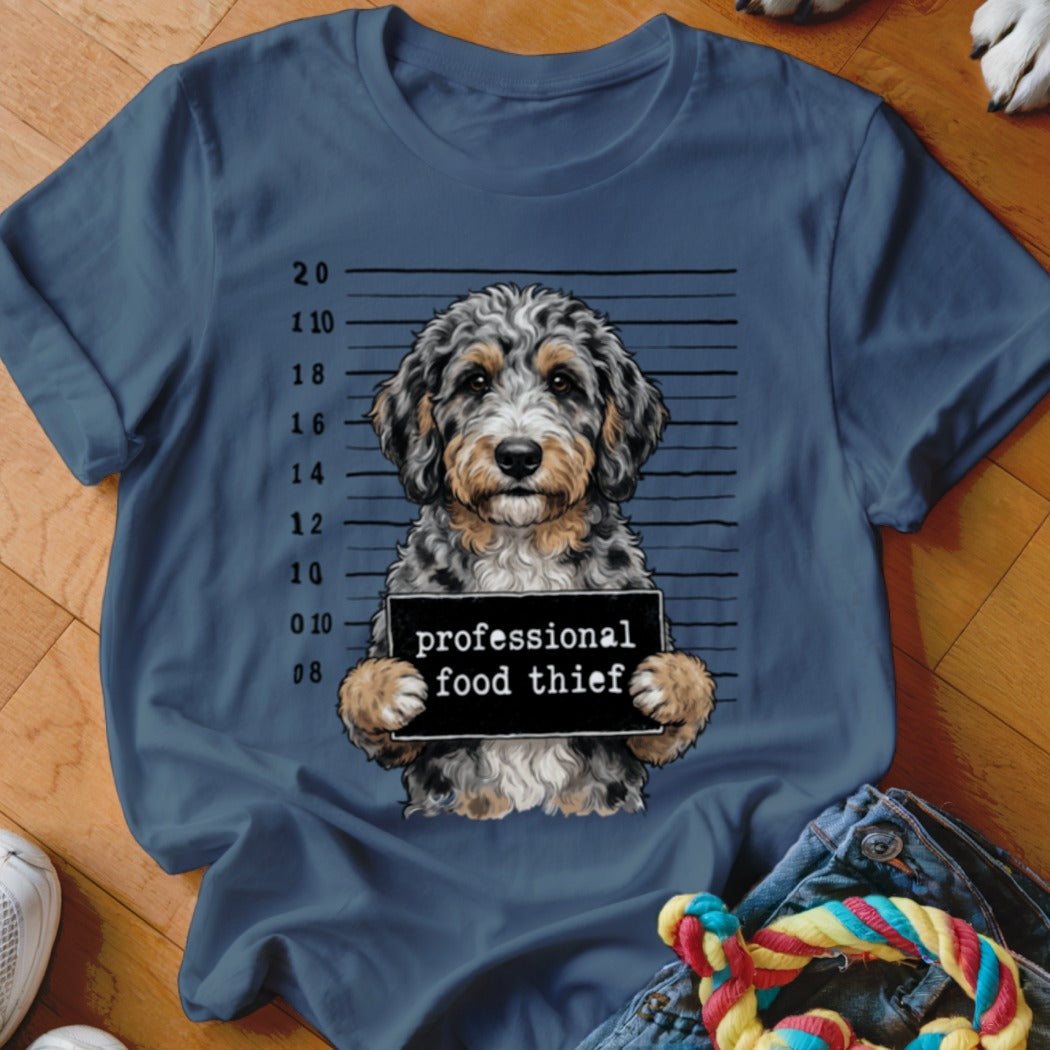Dog in mugshot holding sign that says "professional food thief".