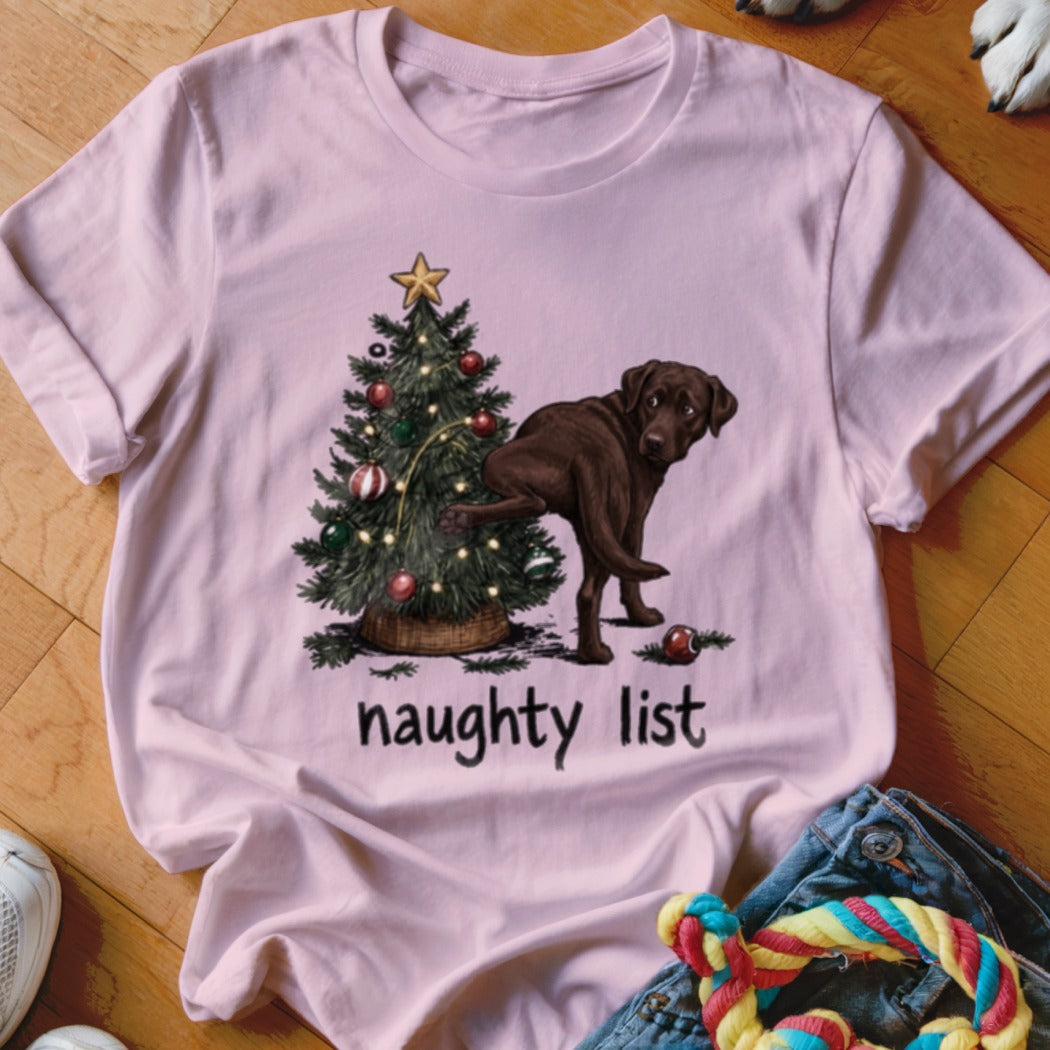 Chocolate lab near Christmas tree with text "naughty list".