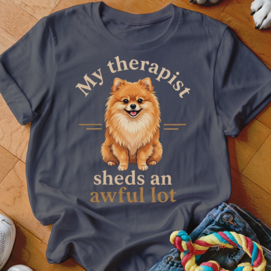 Dark grey t-shirt with Pomeranian and "My therapist sheds an awful lot" text.
