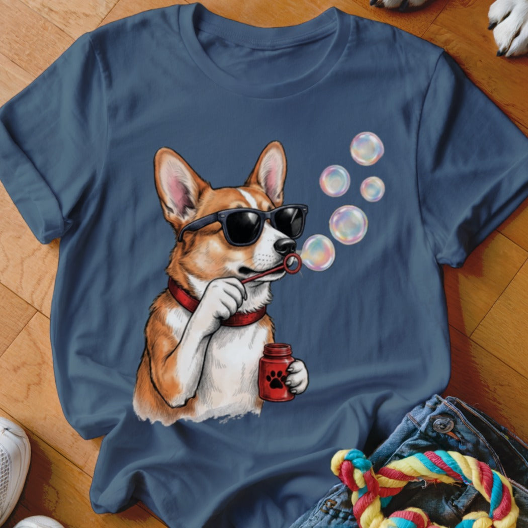 Blue crewneck t-shirt featuring a graphic of a corgi wearing sunglasses and blowing soap bubbles.