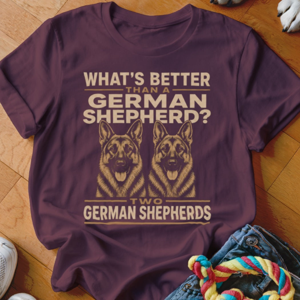 Two German Shepherds, white text on burgundy shirt: "What's better than a German Shepherd? Two German Shepherds?"