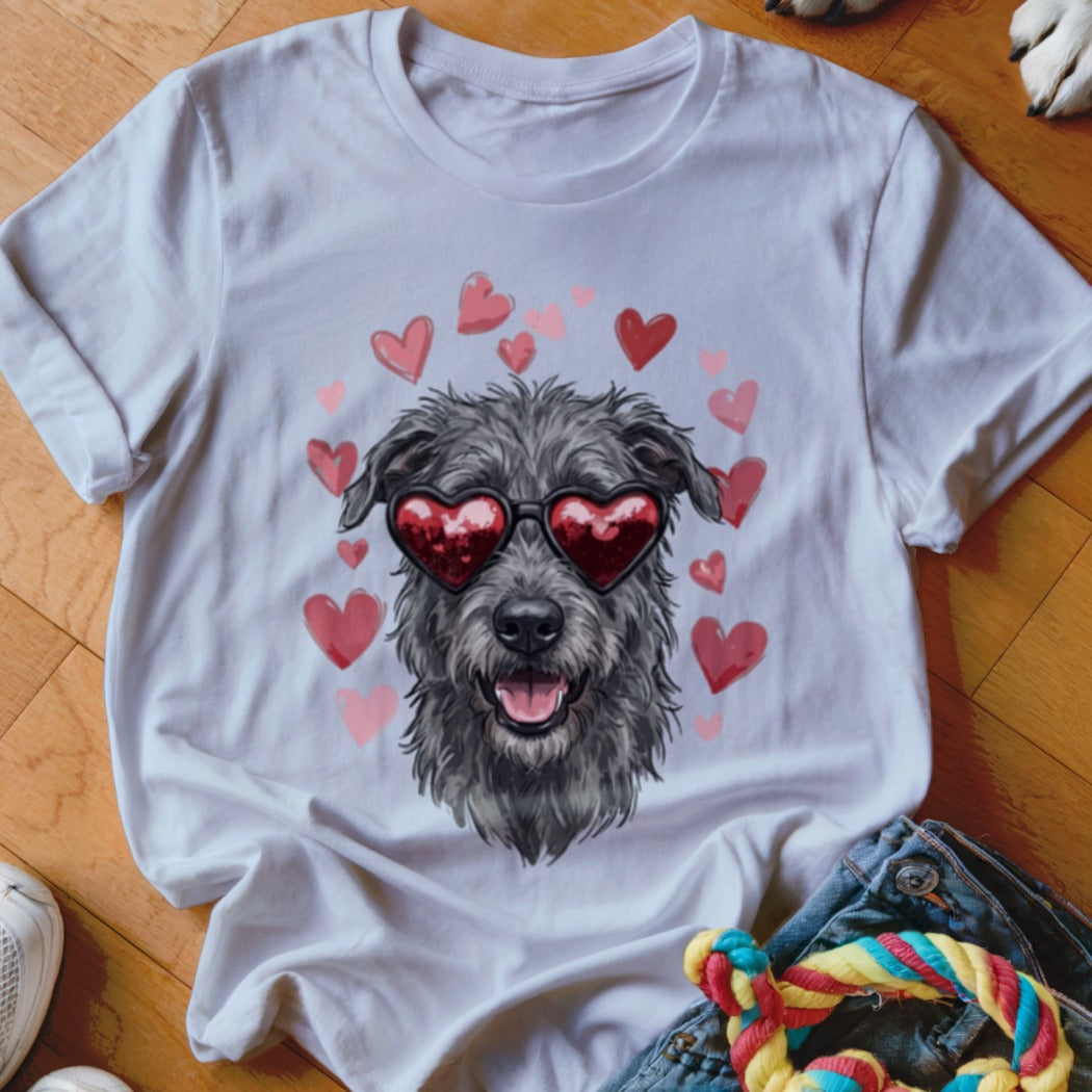 A white t-shirt featuring a graphic of a shaggy gray dog wearing heart-shaped sunglasses, surrounded by pink hearts.
