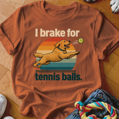 Orange t-shirt with graphic of golden retriever catching tennis ball and text "I brake for tennis balls."
