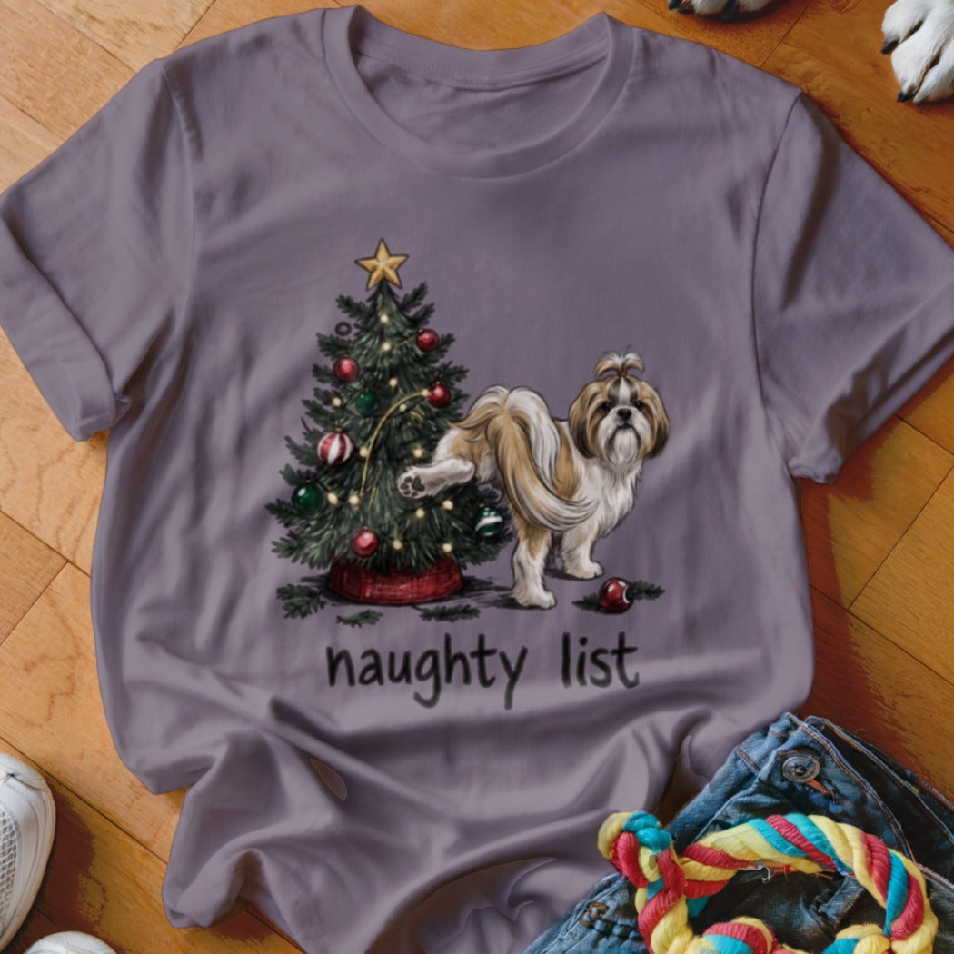 A grey t-shirt featuring a Shih Tzu dog lifting its leg beside a decorated Christmas tree, with the text "naughty list" below.