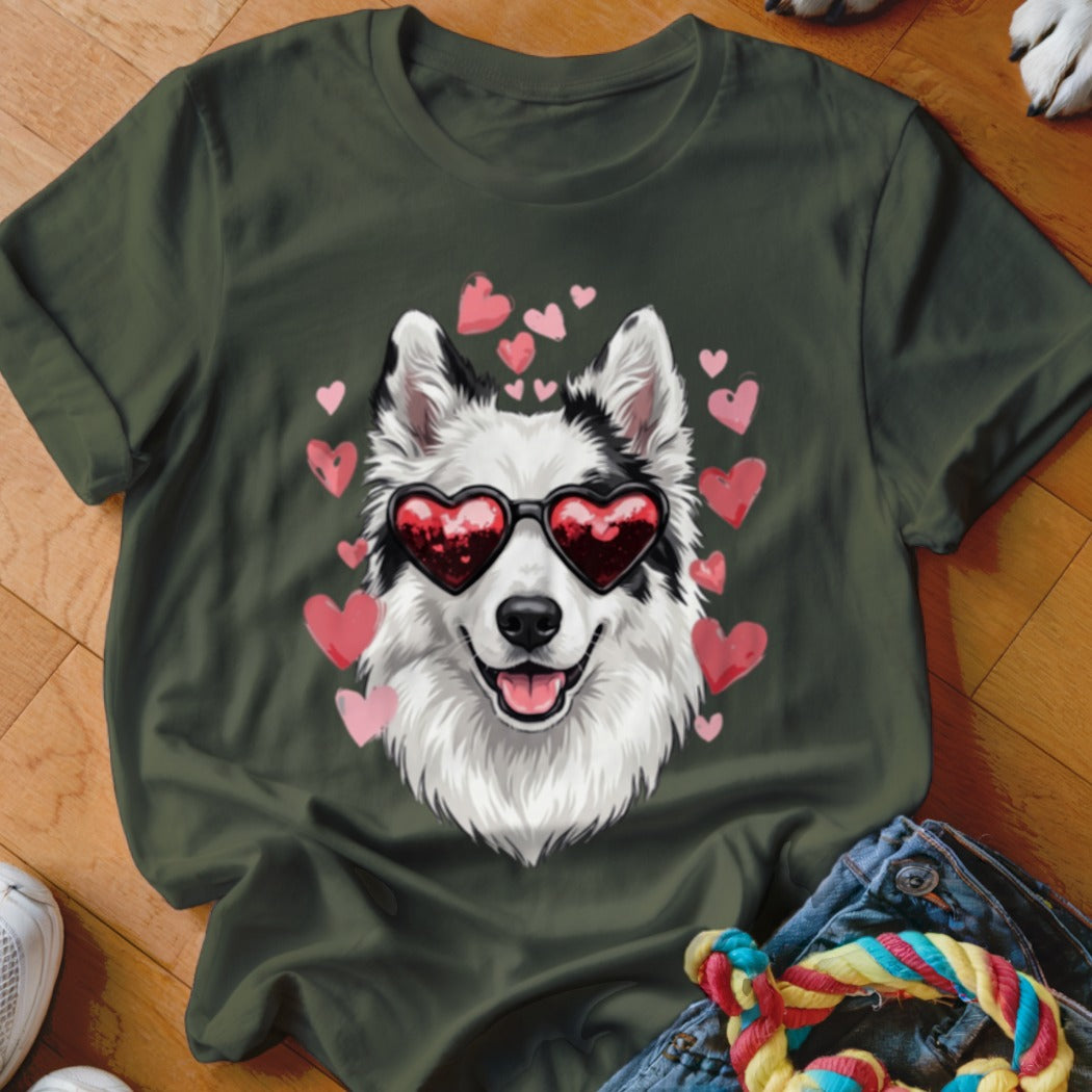 A dark green t-shirt featuring a graphic of a smiling white dog wearing heart sunglasses surrounded by pink hearts.