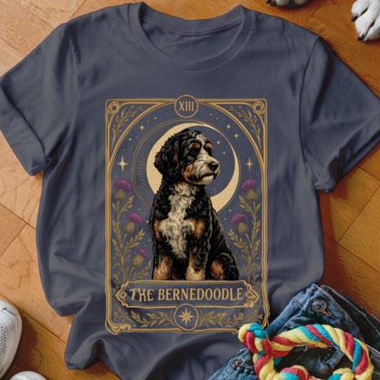 Dark gray t-shirt featuring a tarot card graphic of a Bernedoodle and the text The Bernedoodle.