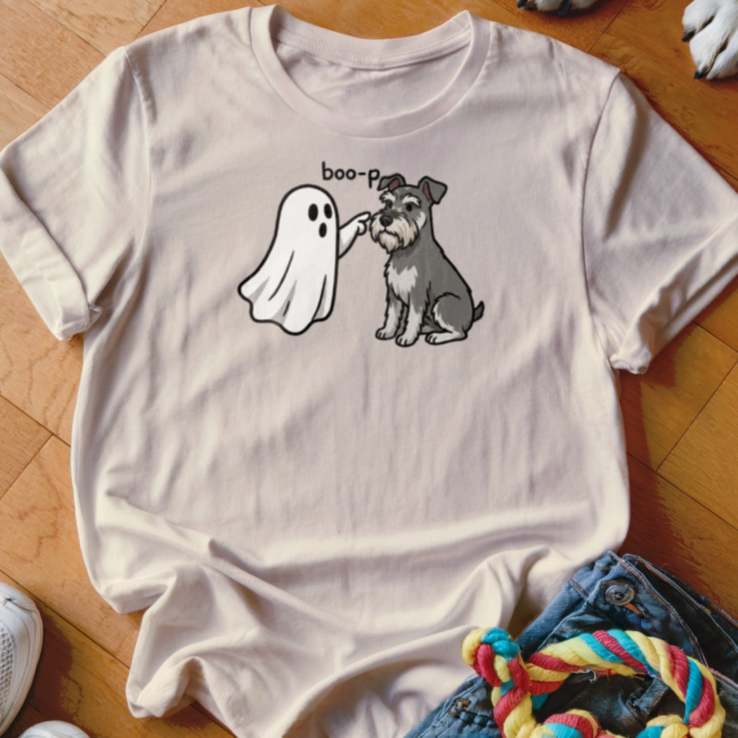 Ghost "boop-p" a sitting schnauzer dog on a light t-shirt.