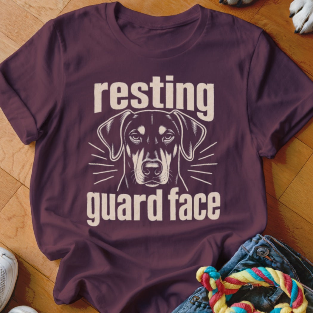 Dark plum t-shirt with graphic of a dog's face and text "resting guard face."