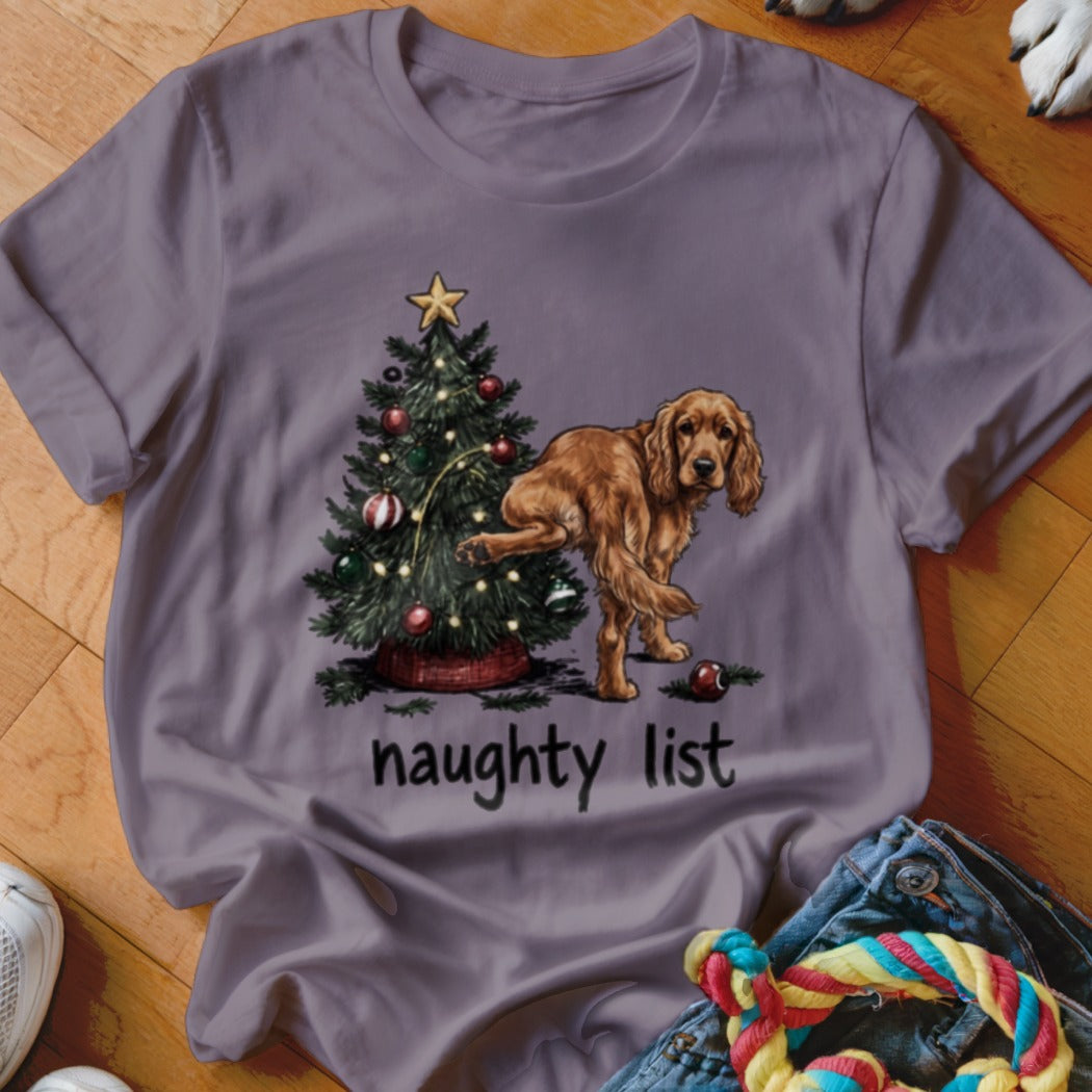 Brown dog in front of a Christmas tree with the text "naughty list".