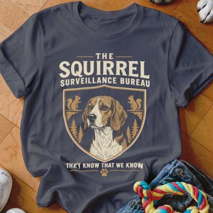 A dark gray t-shirt with a graphic of a beagle inside a crest and the text The Squirrel Surveillance Bureau.