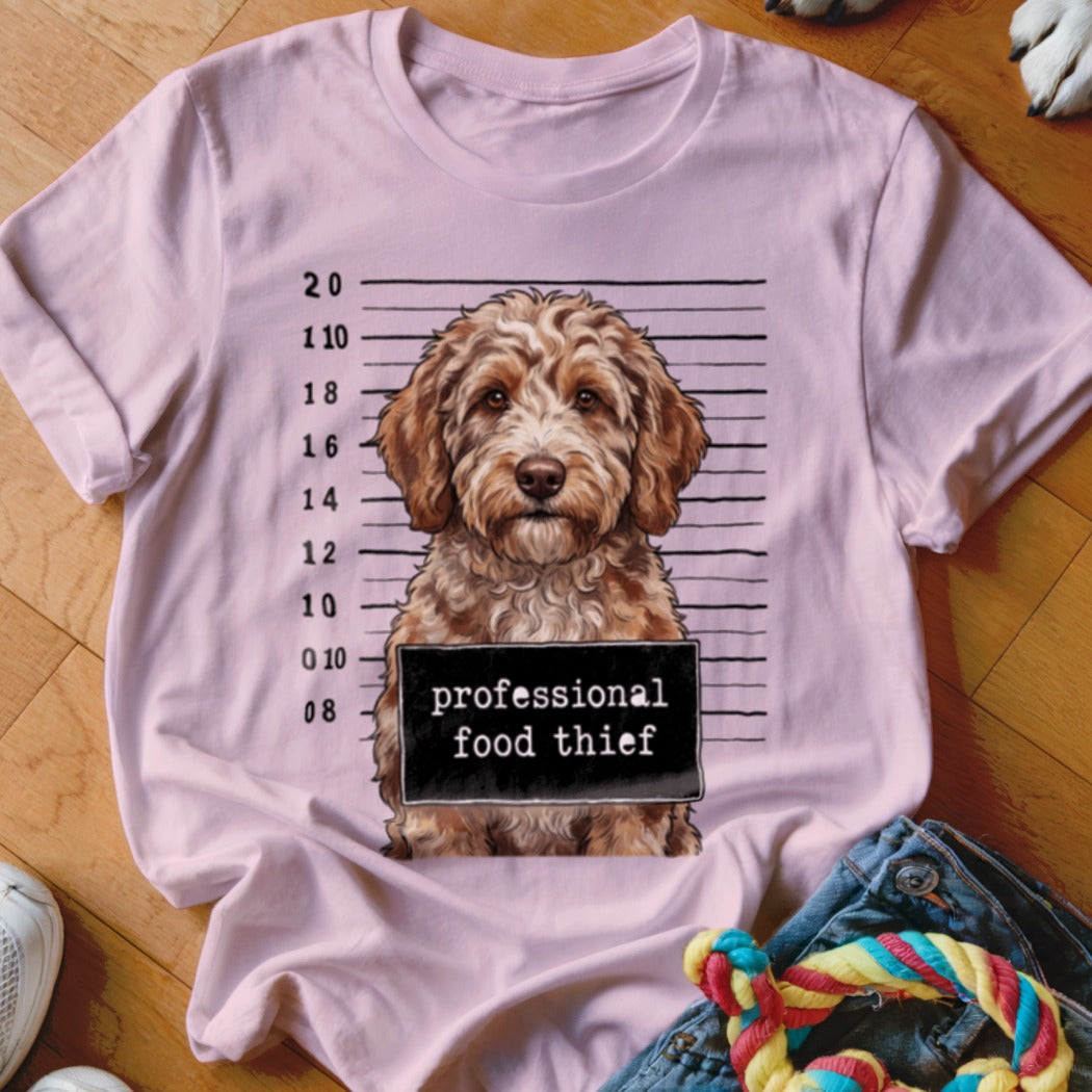 Pink t-shirt with a dog mugshot graphic reading "professional food thief".