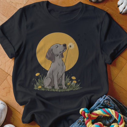 Black t-shirt featuring an illustrated gray dog blowing dandelion seeds against a yellow sun.