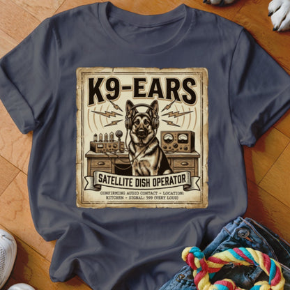 German Shepherd with headphones at radio equipment, "K9-EARS Satellite Dish Operator" text.