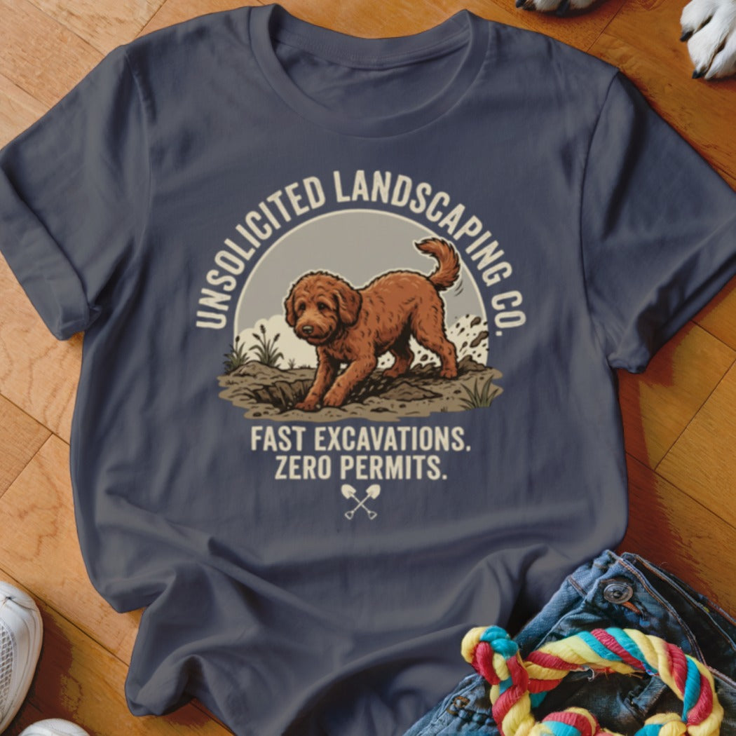 Brown dog digs in dirt on t-shirt with text "Unsolicited Landscaping Co." and "Fast Excavations. Zero Permits."