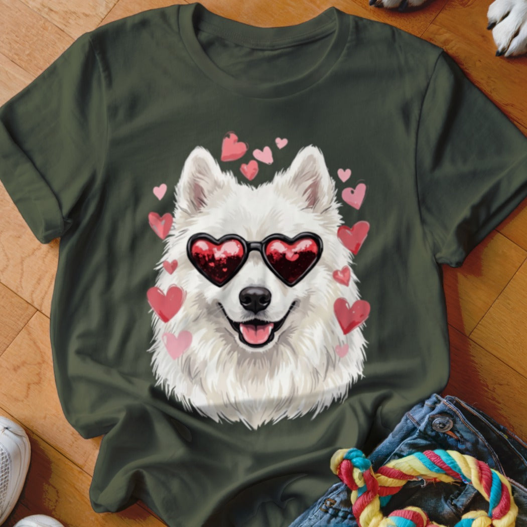 Dark green t-shirt featuring a graphic of a white Samoyed dog wearing heart-shaped sunglasses, surrounded by pink hearts.