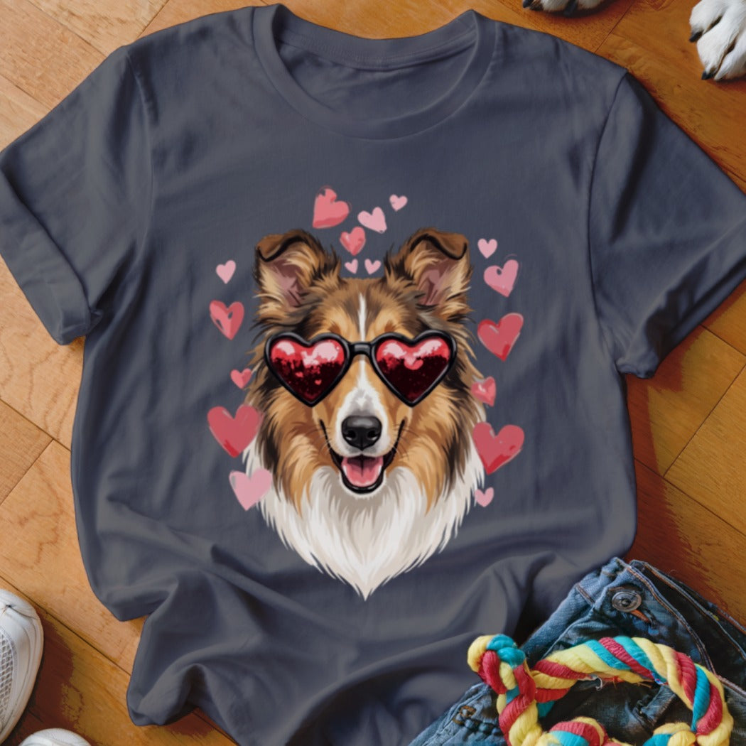 A dark gray t-shirt featuring a graphic of a Sheltie dog wearing heart-shaped sunglasses, surrounded by pink hearts.