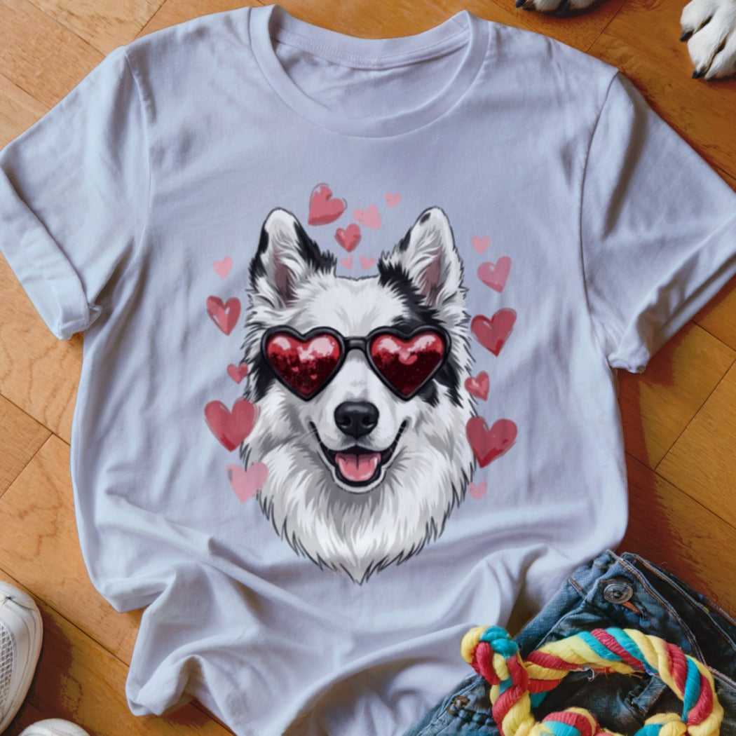 White t-shirt featuring an illustration of a black and white dog wearing heart-shaped sunglasses surrounded by pink hearts.