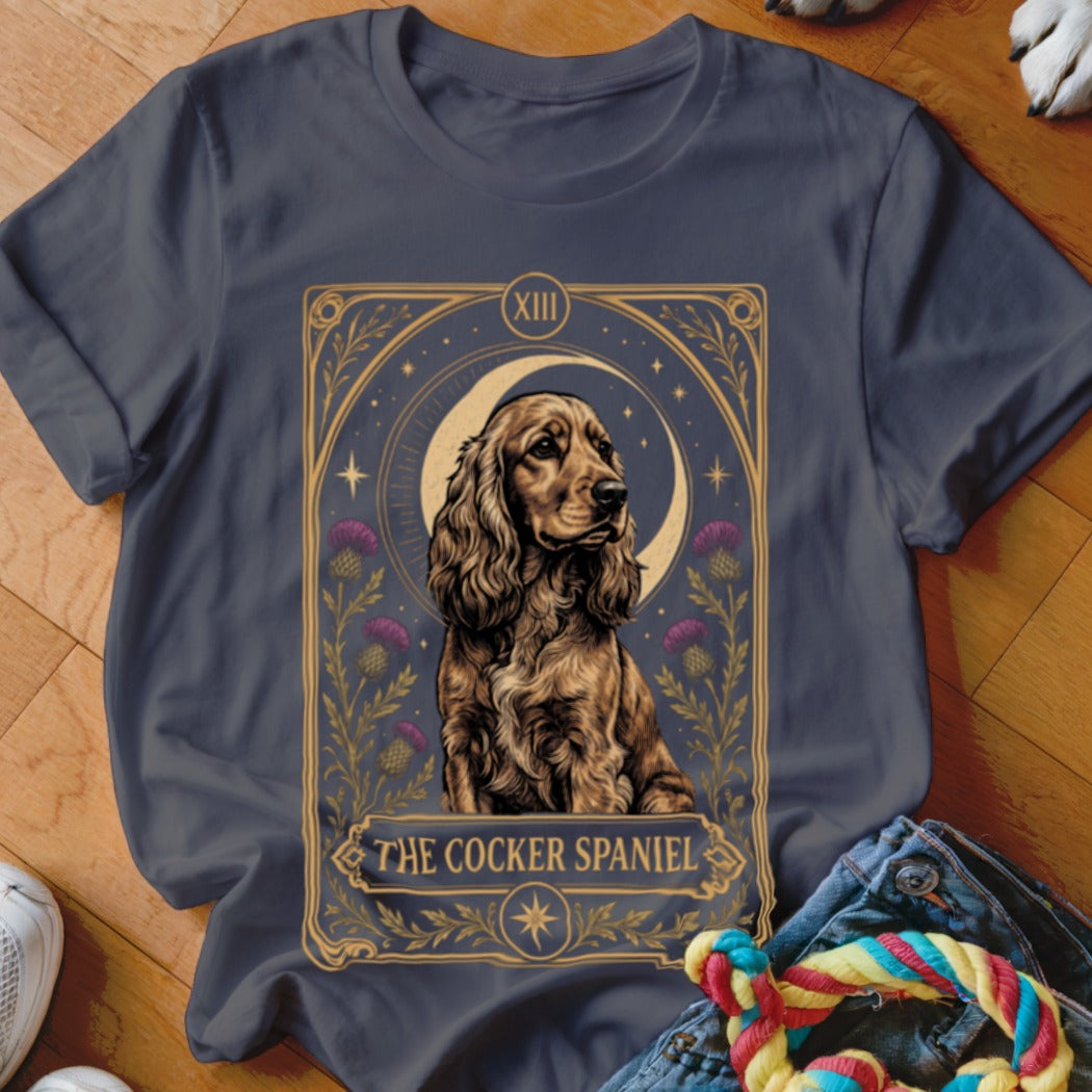 Charcoal t-shirt featuring a tarot card style graphic of a cocker spaniel, crescent moon, and thistles.