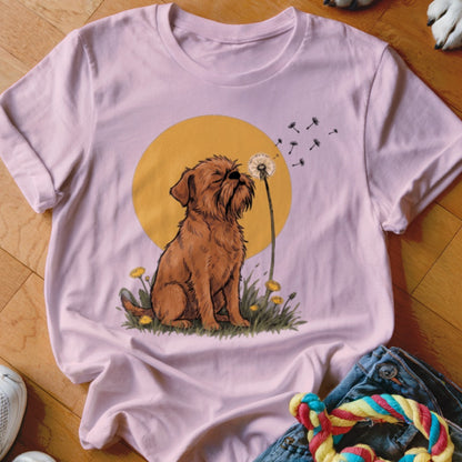 Light pink t-shirt featuring a graphic of a brown dog blowing dandelion seeds against a yellow circle.