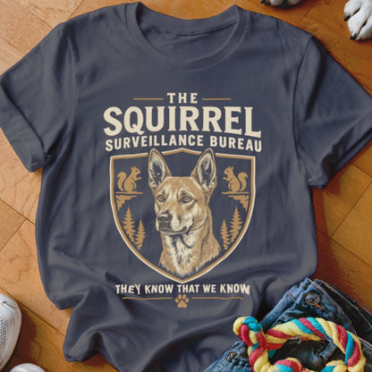 Dark gray t-shirt with a vintage-style graphic featuring a dog, squirrel silhouettes, and text reading The Squirrel Surveillance Bureau.