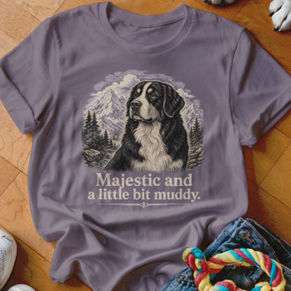 T-shirt featuring a Bernese Mountain Dog with mountains, trees, and text "Majestic and a little bit muddy."