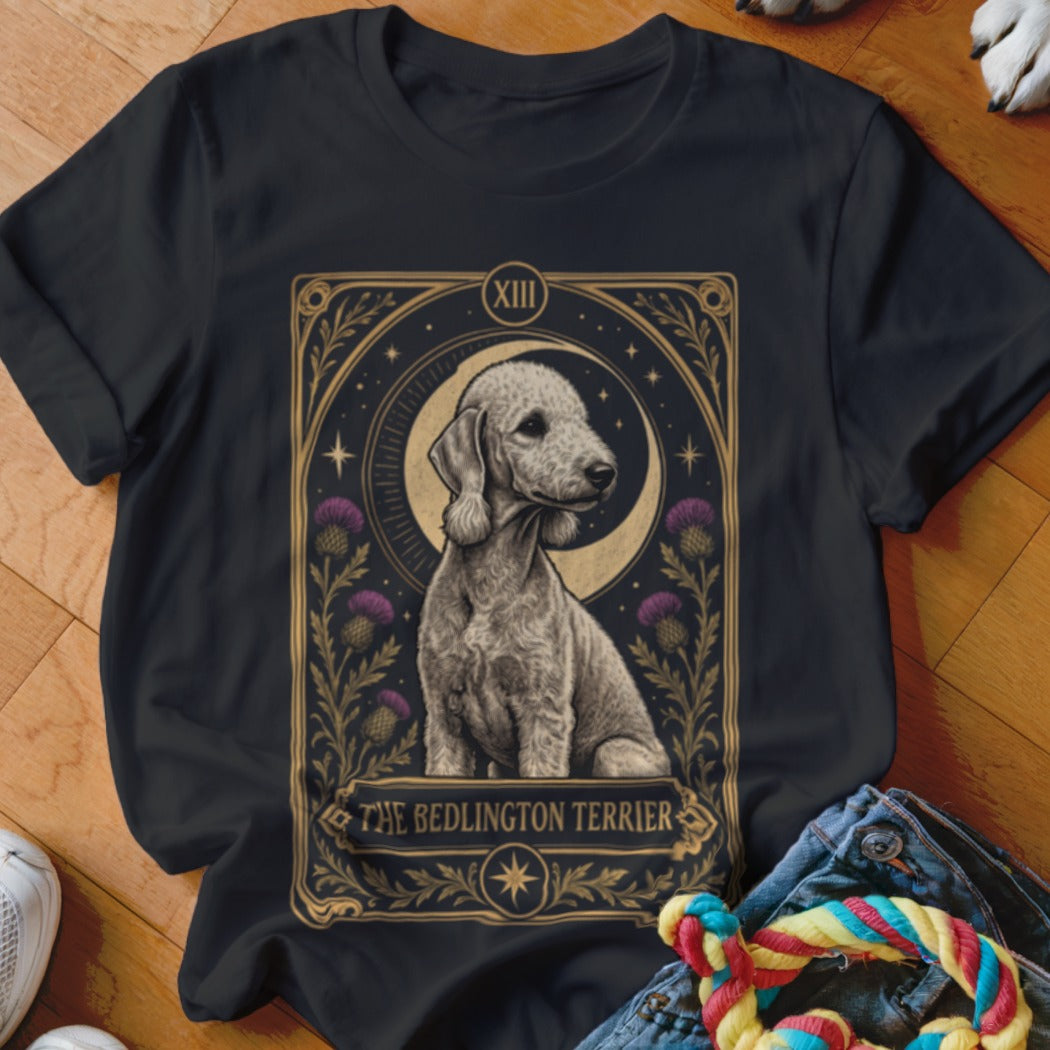 A black t-shirt features a tarot-style graphic of a Bedlington Terrier, crescent moon, thistles, and stars.