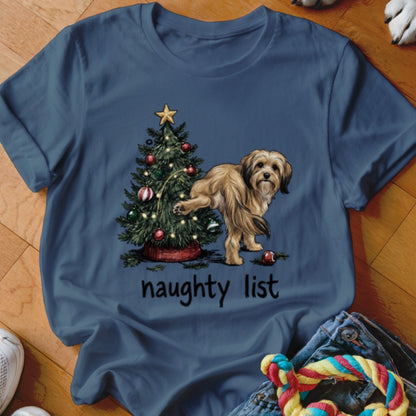 Dog lifting leg on Christmas tree with "naughty list" text.