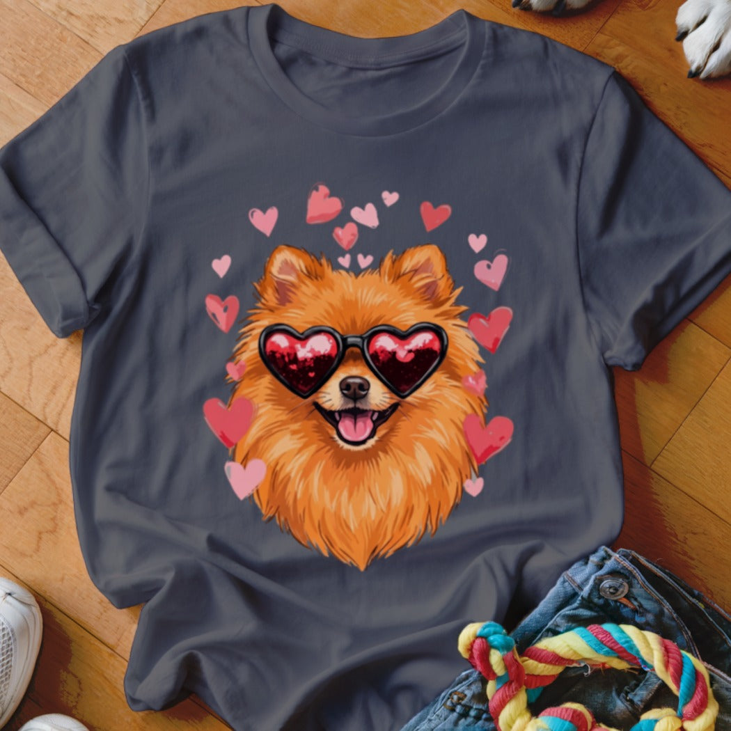 Dark gray t-shirt featuring an illustration of a fluffy Pomeranian wearing heart-shaped sunglasses surrounded by pink hearts.