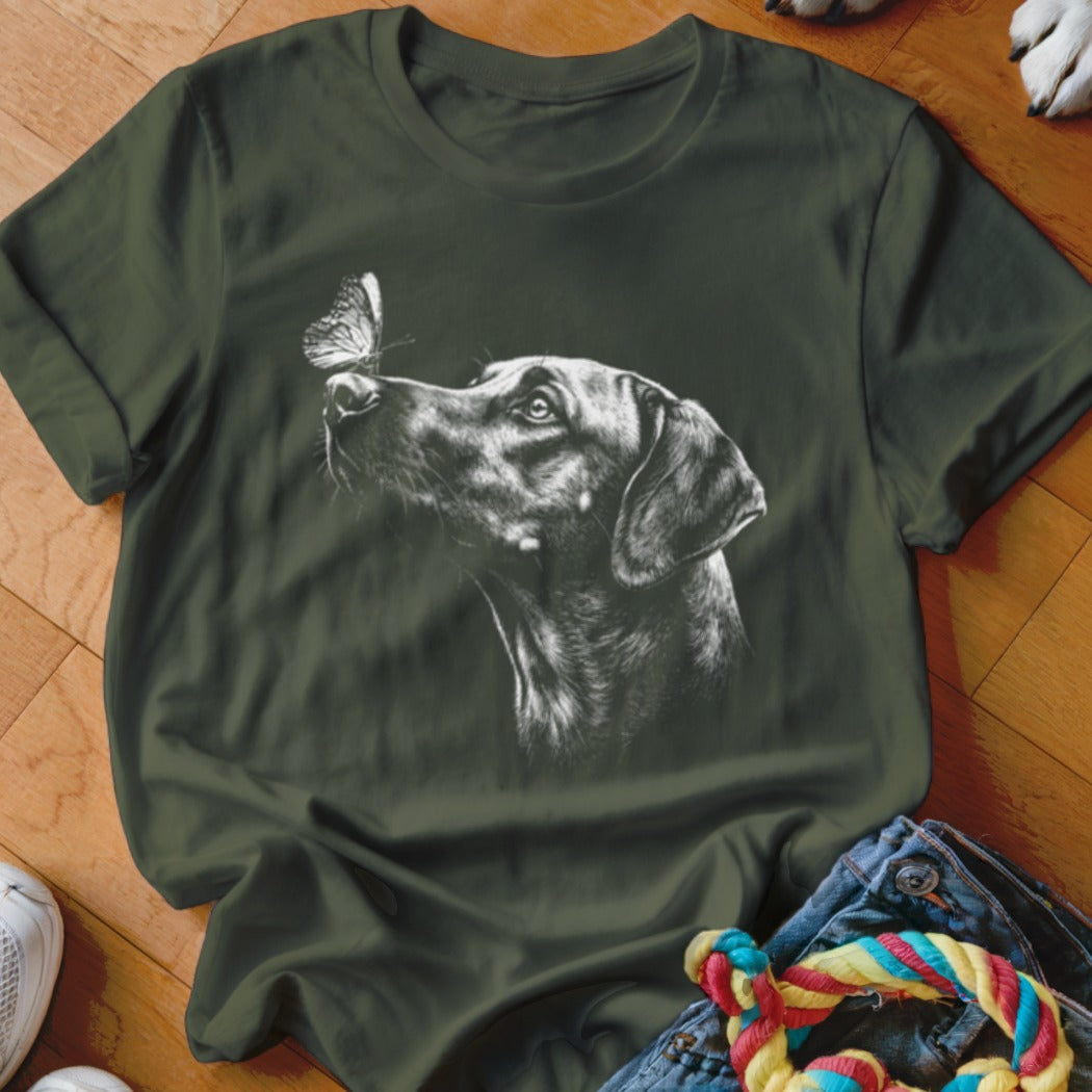Dark green crewneck t-shirt featuring a white sketch graphic of a dog looking at a butterfly on its nose.