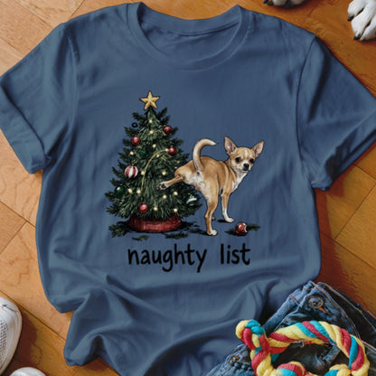Chihuahua lifting leg on Christmas tree with "naughty list" text.