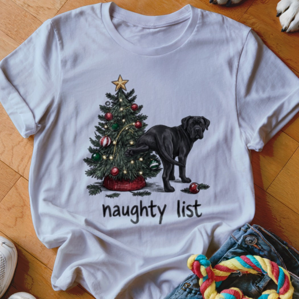A white crewneck t-shirt featuring a graphic of a black dog peeing on a Christmas tree with text that says naughty list.