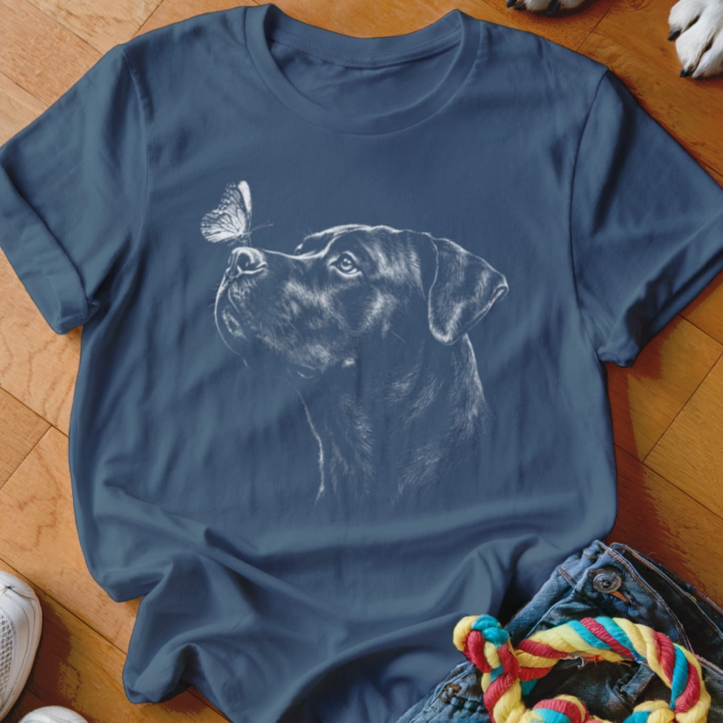 Navy blue t-shirt featuring a white line drawing of a dog looking at a butterfly.