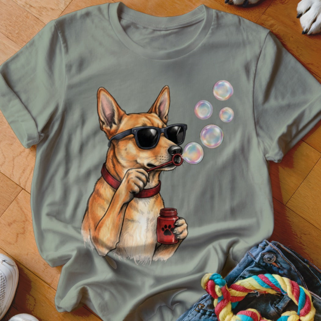 Olive green crewneck t-shirt featuring an illustration of a dog wearing sunglasses and blowing soap bubbles.