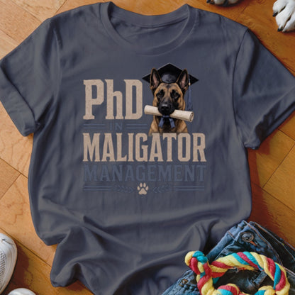 T-shirt design: dog with graduation cap and diploma, reads "PhD in Maligator Management."